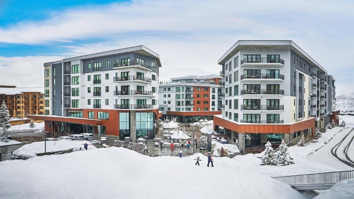 Luxury mountain lodge lit up at dusk in Park City